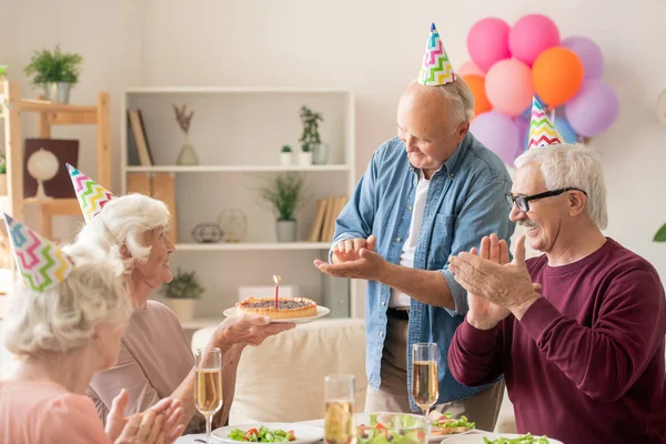 Senioren Klatschen Die Hände Während Sie Ihren Freund Mit Geburtstagstorte — Stockfoto