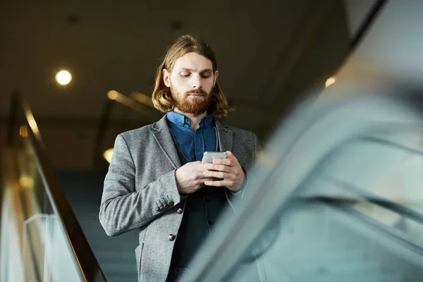 Contemporary Businessman Mobile Gadget Texting While Moving Escalator Modern Airport — Stock Photo, Image