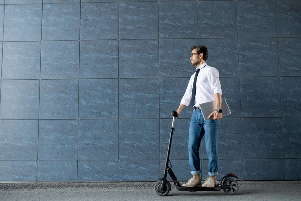Mobile Businessman Folded Laptop Moving Scooter Blue Wall Modern Building — Stock Photo, Image