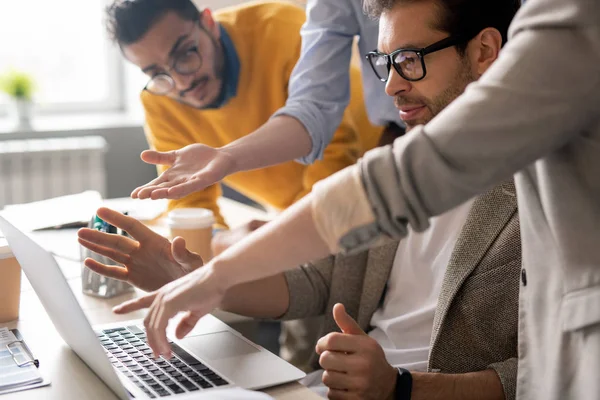 Group Serious Young Business Specialists Pointing Laptop Monitor Discussing Web — Stock Photo, Image