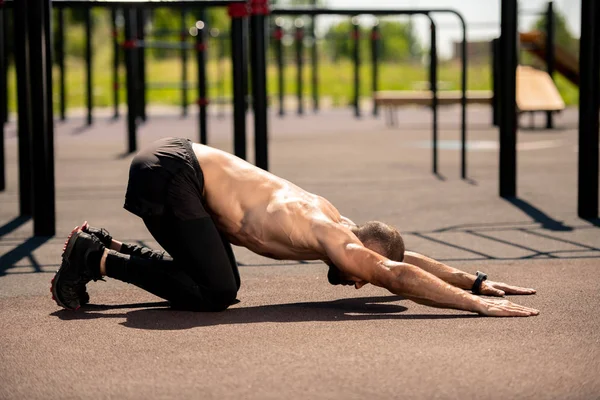 Topless Sportsman Stretching Forwards While Standing Bent Knees Sportsground Exercise — Stock Photo, Image