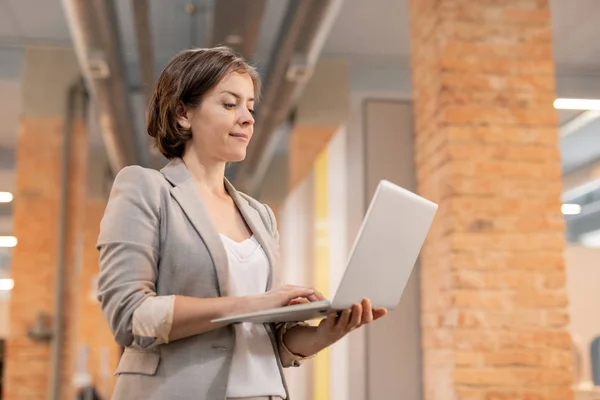 Content Successful Young Businesswoman Jacket Standing Loft Space Checking Online — Stock Photo, Image