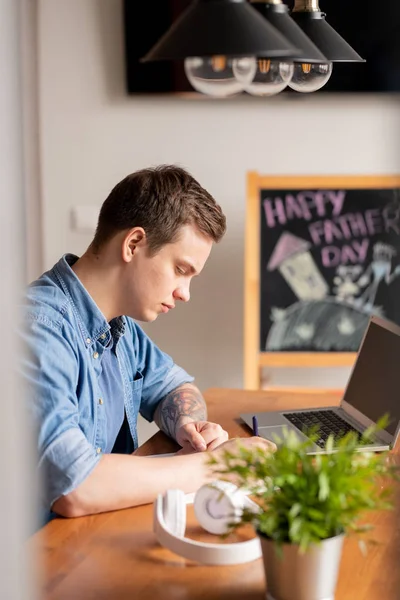 Συγκεντρωμένη Νεαρό Αρσενικό Ελεύθερος Επαγγελματίας Denim Shirt Κάθεται Στο Τραπέζι — Φωτογραφία Αρχείου