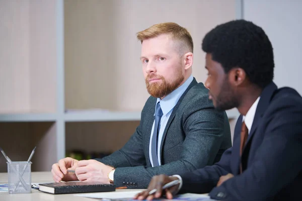 Serious Young Businessman Listening Speaker Seminar Conference His African Colleague — Stock Photo, Image