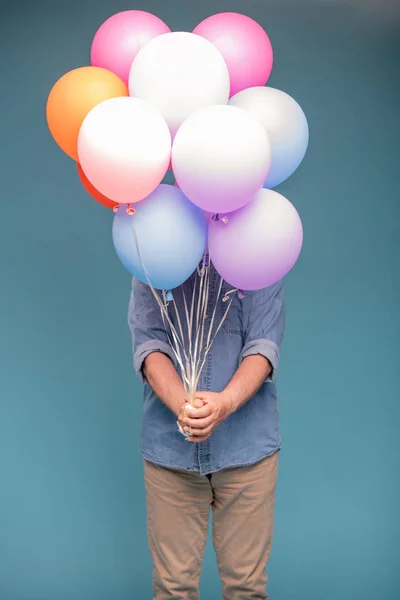 Dospělý Muž Přesnotě Nosí Hromadu Barevných Balónků Zatímco Stojí Izolaci — Stock fotografie
