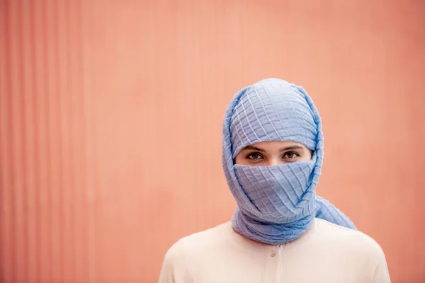年轻的伊斯兰女性的头和肩膀在头巾站在粉红色的背景孤立 — 图库照片
