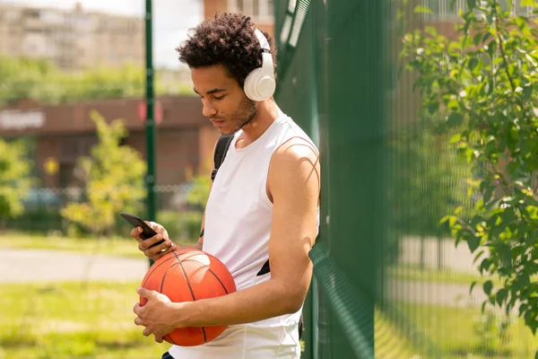 Jonge Knappe Atleet Sportswear Luisteren Naar Muziek Koptelefoon Scrolen Smartphone — Stockfoto