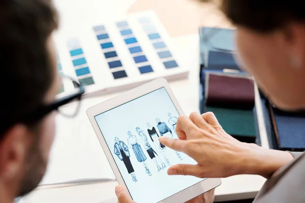 Young Female Fashion Designer Pointing One Model Sketches Touchscreen While — Stock Photo, Image