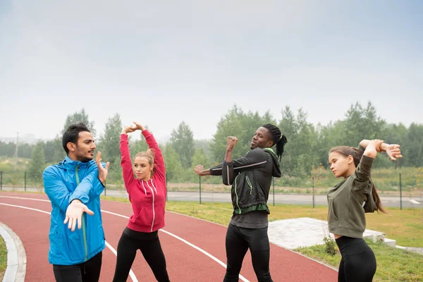 Group Young Sporty Intercultural Friends Activewear Doing Warming Exercises Stadium — Stock Photo, Image