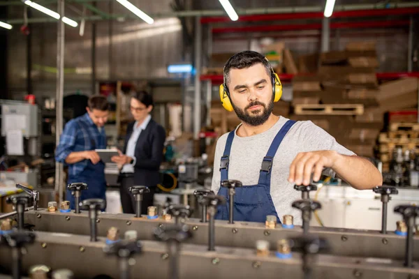 Joven Mecánico Barbudo Auriculares Protectores Reparando Máquina Industrial Área Trabajo — Foto de Stock