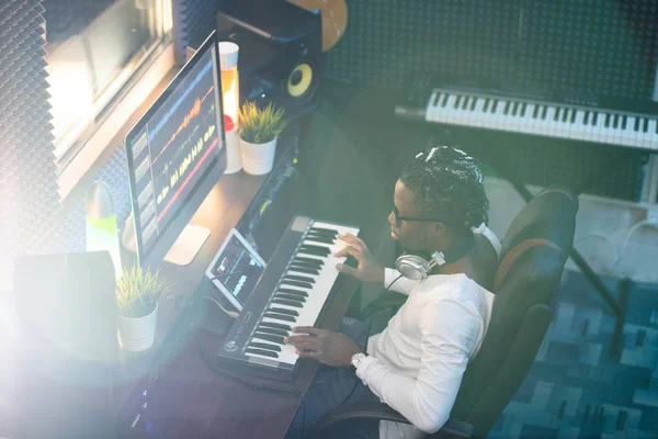 Jovem Músico Africano Casualwear Olhando Para Tela Computador Enquanto Sentado — Fotografia de Stock