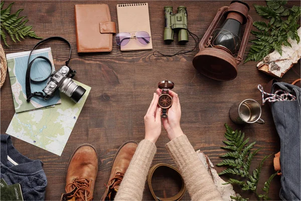 Unrecognizable Hiker Sweater Holding Open Compass Wooden Table Hiking Stuff — Stock Photo, Image