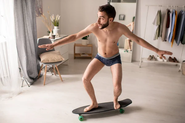 Hilarious Young Bearded Man Underwear Skateboarding Outstretched Arms Home Isolation — Stock Photo, Image