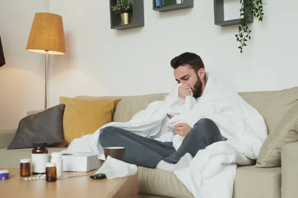 Zieke Jongeman Met Griep Coronavirus Zittend Bank Woonkamer Terwijl Hij — Stockfoto