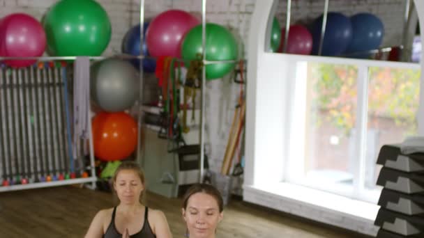傾斜ダウンショットの3リラックス妊娠中の女性座ってヨガマットと練習瞑想 — ストック動画