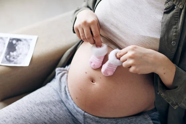 Manos Una Joven Embarazada Sosteniendo Pequeños Calcetines Para Futuro Bebé — Foto de Stock