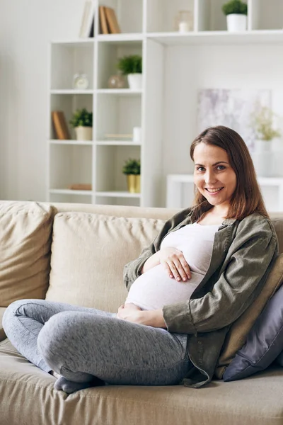 Felice Giovane Donna Incinta Casualwear Seduta Tra Cuscini Sul Divano — Foto Stock