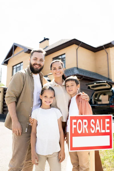 Portrait Cheerful Young Parents Embracing Adolescent Kids While Standing Old — Stock Photo, Image