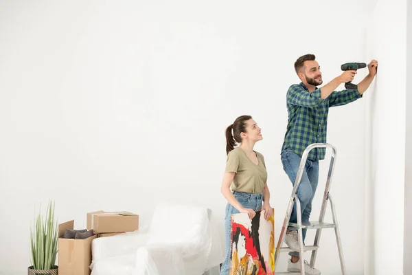 Positive Young Man Standing Step Ladder Using Electric Screwdriver While — Stock Photo, Image