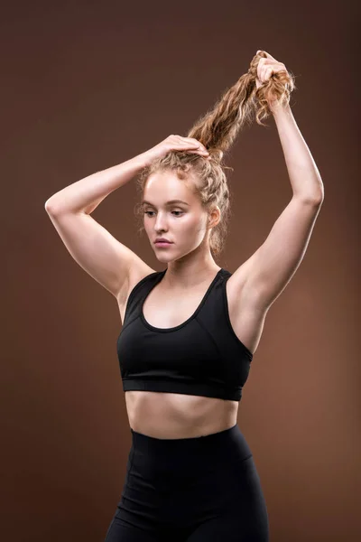 Slim Young Woman Black Tracksuit Holding Her Long Blond Curly — Stock Photo, Image
