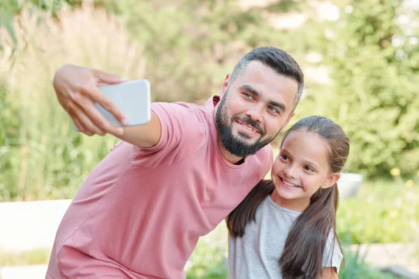 Modern Yetişkin Baba Soluk Pembe Tişört Giyip Kızıyla Fotoğraf Çekiyor — Stok fotoğraf