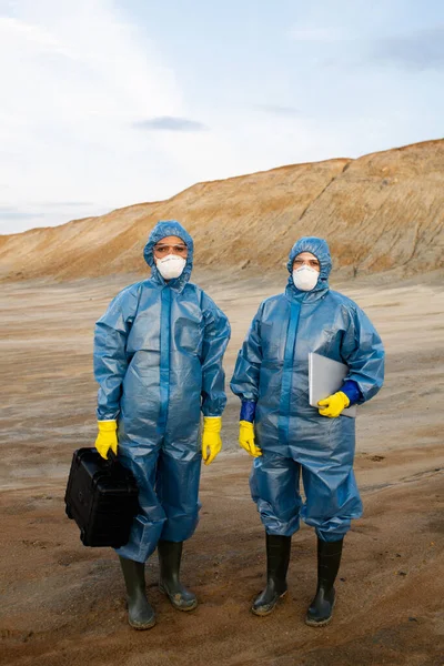 Two Young Female Researchers Protective Workwear Standing Polluted Soil Abandoned Royalty Free Stock Images