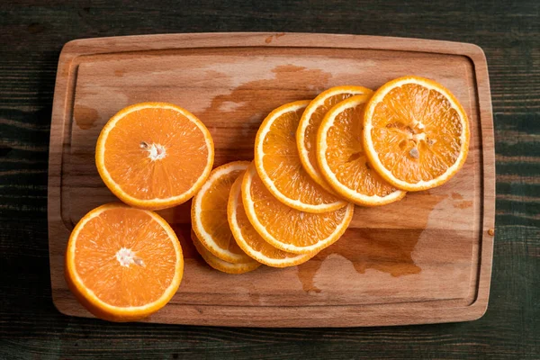 Heap Slices Fresh Dry Oranges Rectangular Wooden Chopping Board Dark — Stock Photo, Image