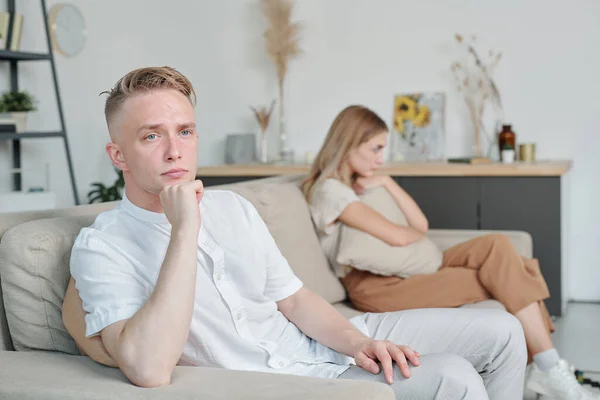 Offended Young Man Sitting Couch His Unhappy Wife Background While — Stock Photo, Image