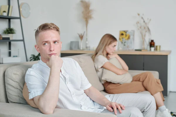 Young Man Indifferent Facial Expression Sitting Couch While Ignoring His — Stock Photo, Image