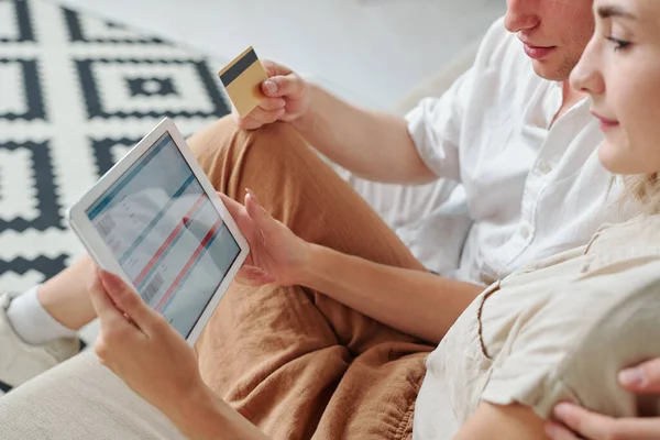 Young Affectionate Couple Sitting Sofa Buying Airplane Tickets Online While — Stock Photo, Image