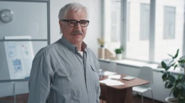 Kollarını kavuşturan kıdemli adam portresi