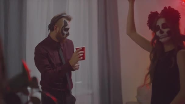 Handheld Slowmo Shot Bearded Man Wearing Skull Makeup Drinking Alcohol — Stock Video