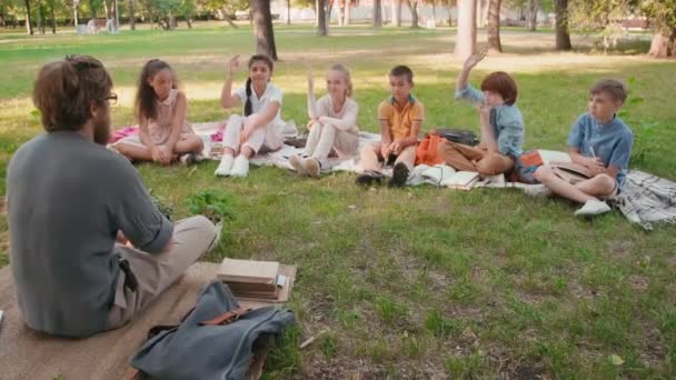 Medium Shot Bearded Male Primary School Teacher Sitting Cross Legged — Stock Video