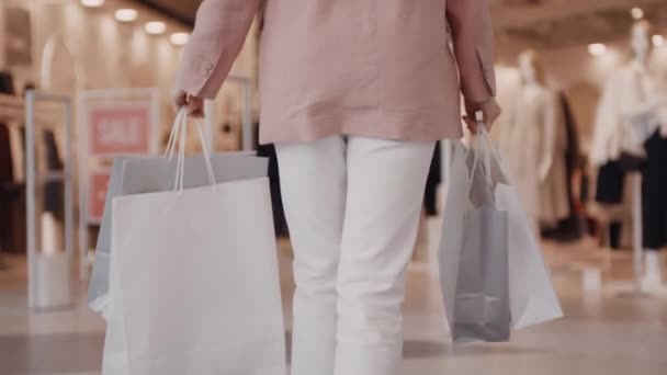 Tracking Young Woman Shopping Bags Smiling Walking Clothes Store Mall — Stock Video