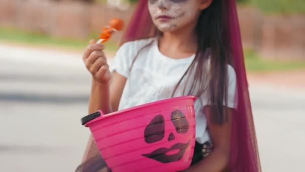 Chica extática en disfraz de Halloween posando después de engañar o tratar — Vídeo de stock
