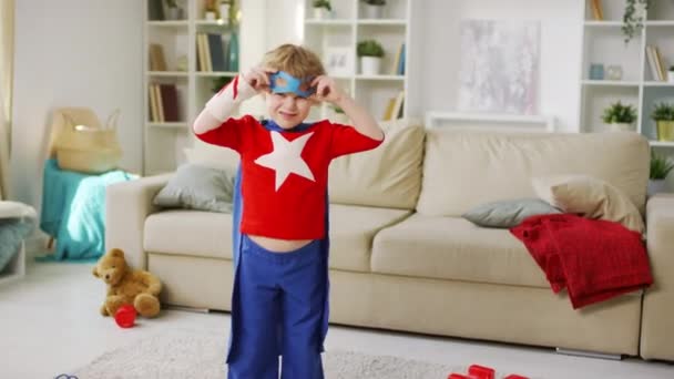 Střední Záběr Malého Kudrnatého Chlapce Rozmazaném Pozadí Kostýmu Superhrdiny Modrým — Stock video