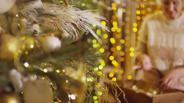 Macro Shot Elderly Lady Hands Dressing Christmas Tree Full Golden — Stock Video