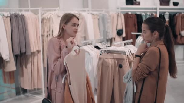 Sequence Shots Female Friends Chatting Choosing Garments While Shopping Clothes — Stock Video