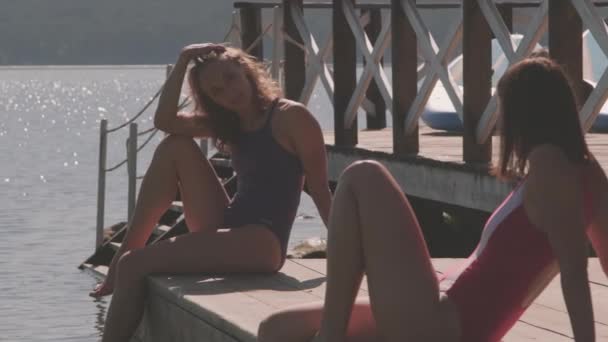 Medium Shot Natural Women Sitting Pier Lake Chilling Talking Blue — Stock Video