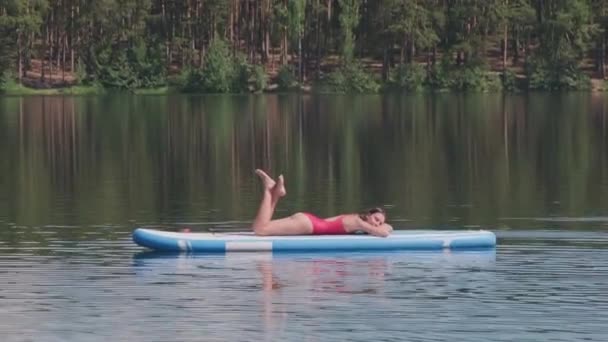Side View Stab Shot Attractive Woman Red Swimwear Lying Paddleboard — Stock Video