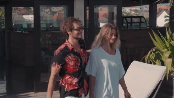 Modern Çiftin Havuz Kenarında Yürürken Şezlonga Yaklaşırken Güneş Banyosuna Yalan — Stok video