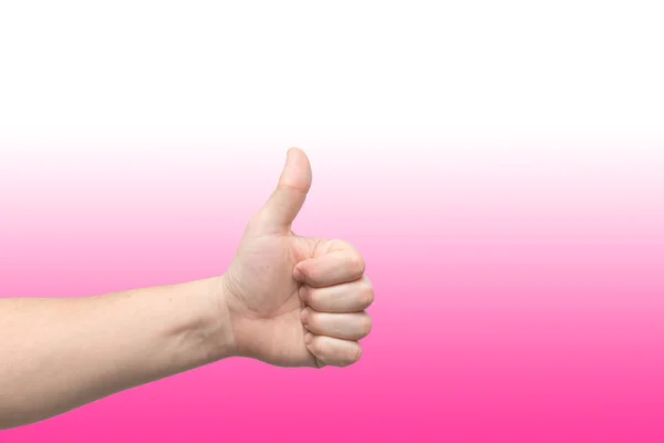 분홍색 그라데이션 배경에 대한 엄지 손가락을 보여주는 남성 손의 클로즈업 — 스톡 사진