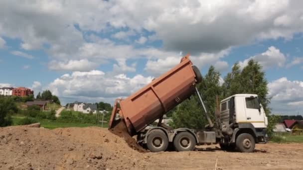 ダンプトラックは 建設中の砂をアンロードします 晴れた日 — ストック動画