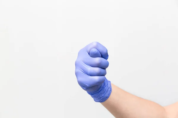 Fig as a hand gesture, denoting humiliation or denial. Male hand in purple latex glove. — Stock Photo, Image