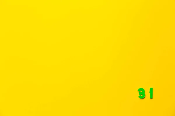 플라스틱 장난감 31은 노란색 배경에 오른쪽하단 모서리에 — 스톡 사진