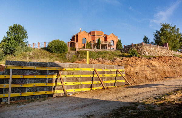The construction of a retaining wall or counterfort, formwork, reinforced, preparation to pour concrete, construction site. Improvement of the territory. Preventive measures against landslide.