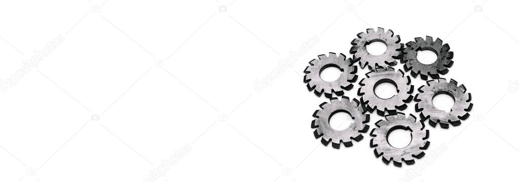 Banner with several metal milling disc cutters for industrial equipment. The tool is isolated on a white background with free copy spase. Close-up.