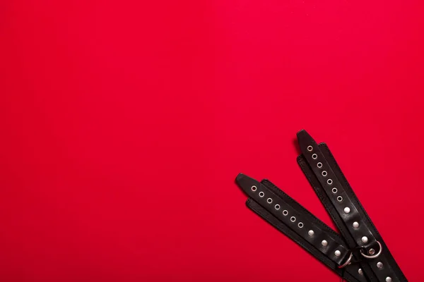 Red Color Banner Black Leather Bracers Metal Rivets Shackling Hands — Stock Photo, Image