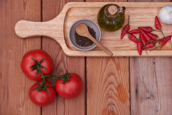 domates, biber, zeytin yağı bir ahşap plaka üzerinde. ülke stil
