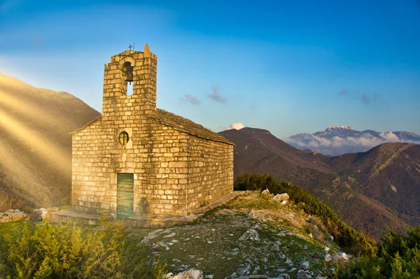 the old church in the mountains against the sky and mountains